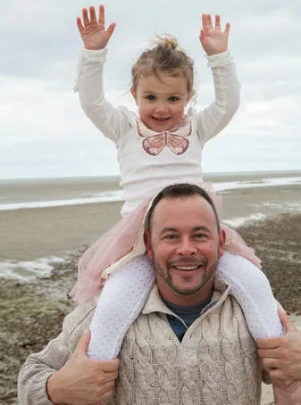 Dr. Brian J. Trudnak, DC, with his daughter on the beach
